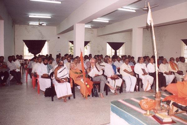 Distinguished scholars seated in the seminar audience