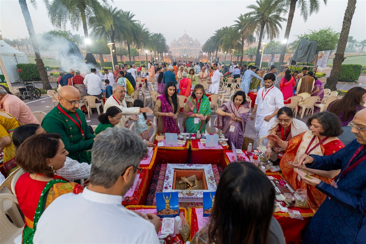 Devotees participate in the yagna rituals