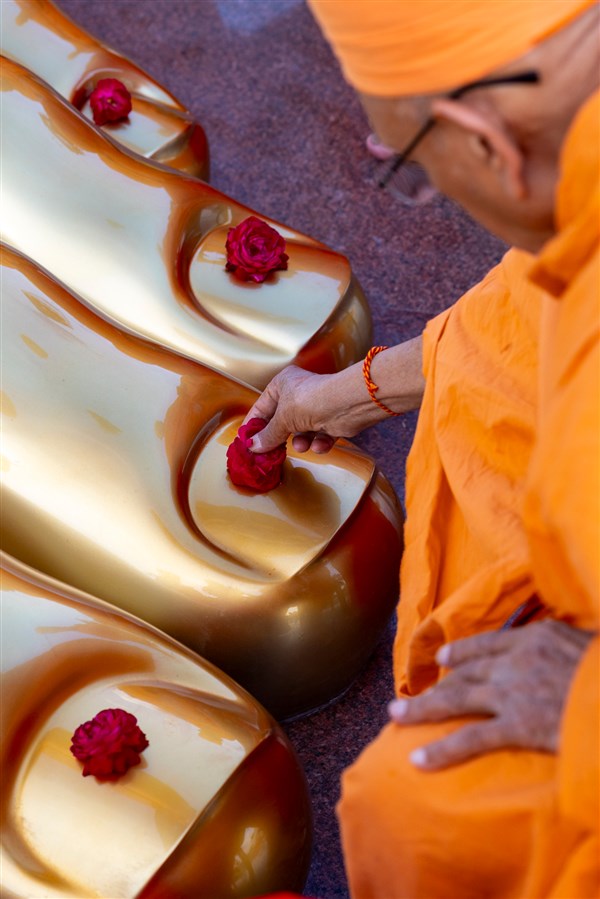 Pujya Kothari Swami places a flower on the holy feet of Tapomurti Shri Nilkanth Varni