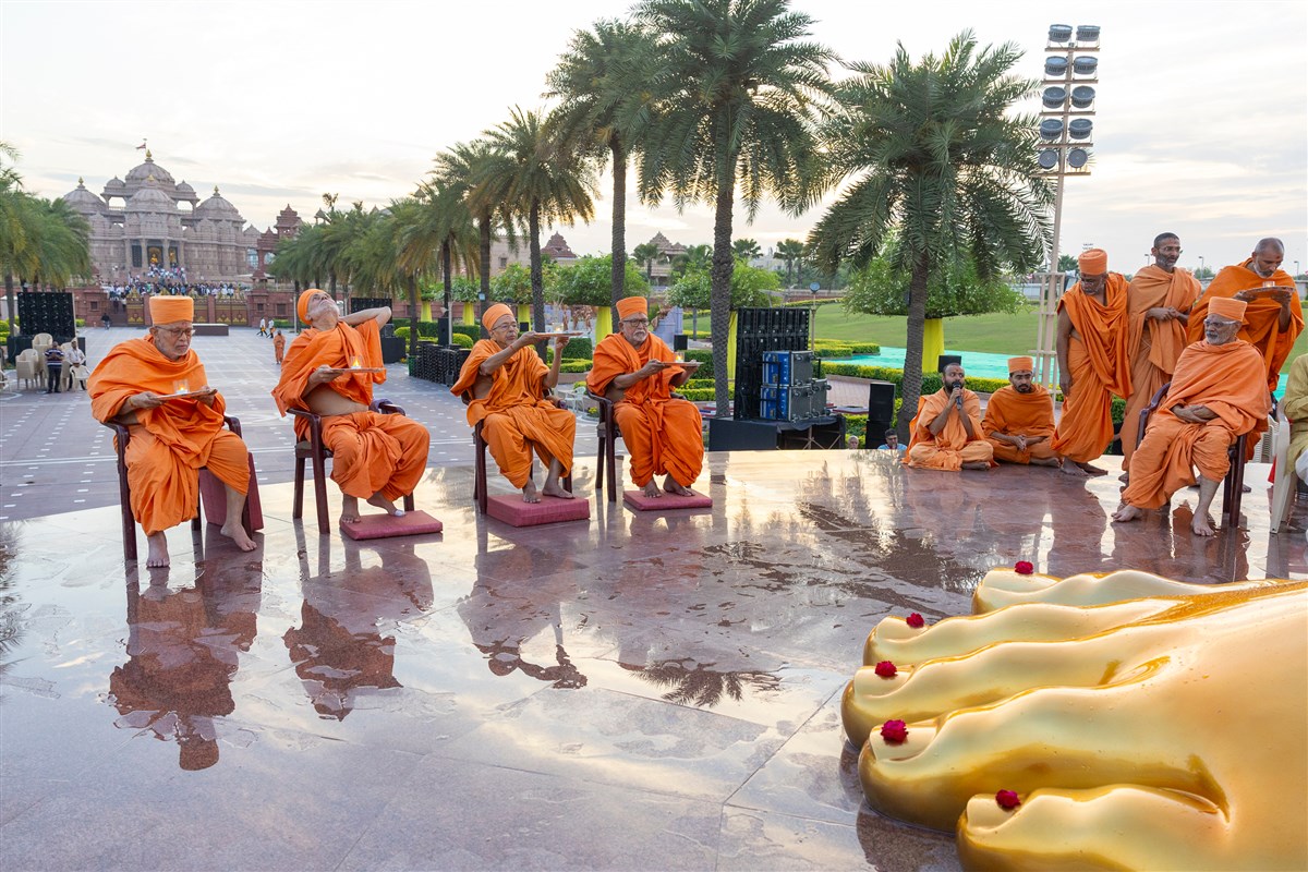 Senior swamis perform the arti