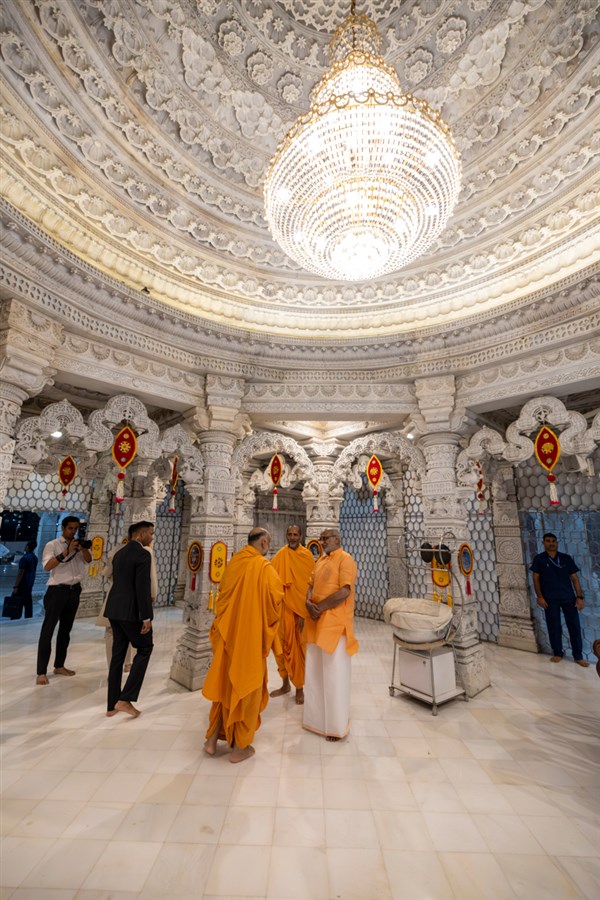 Shri C.P. Radhakrishnan with swamis beneath the mandir dome