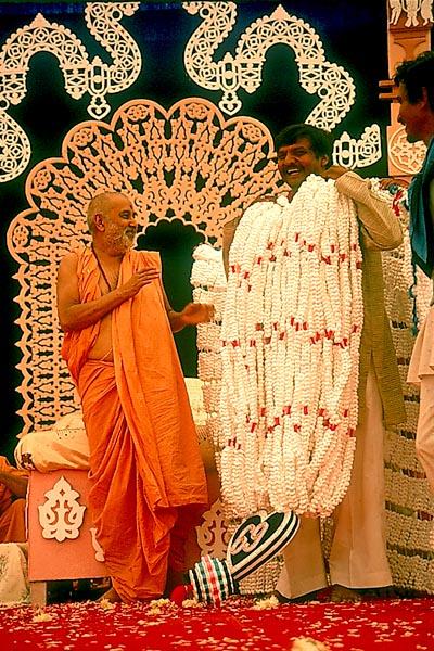 Swamishri blesses Laljibhai with the holy garland 
