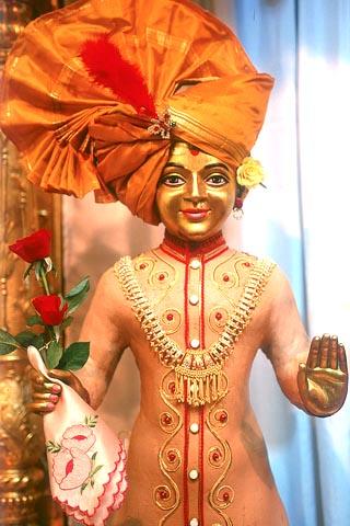 Shri Harikrishna Maharaj beautifully decorated with chandan, lace and ornaments