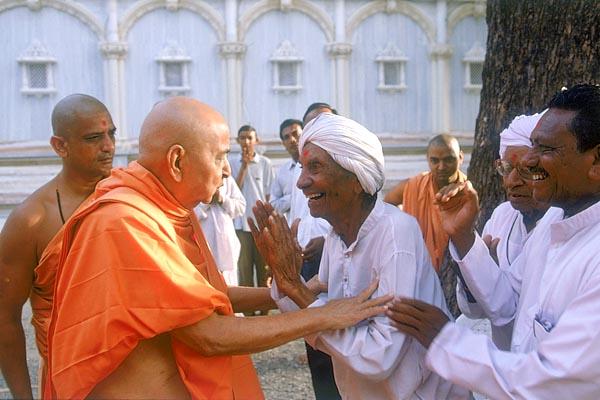 Swamishri blesses the same aged devotee who is delighted with Swamishri's care and love