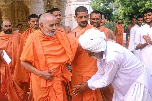 Swamishri blesses and converses with Bhimbha - a dedicated devotee  