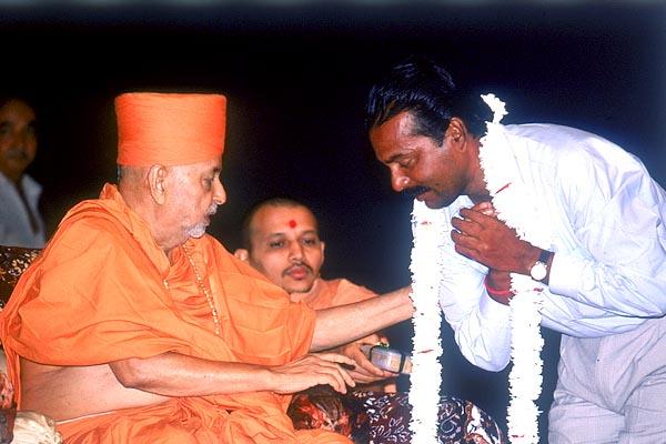 Swamishri blesses the local devotee Shri Pitambar Jenna 