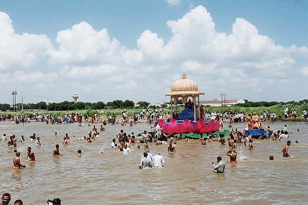 Sadhus and devotees take a holy dip in the river after the celebrations