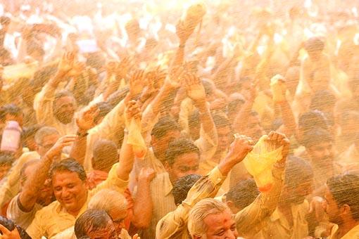   Flushed in a spray of colored water, the devotees ecstatically relish the ultimate moments of the festival