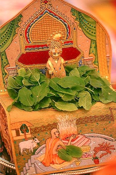 Yagna ,Swamishri offers tulsi leaves to Shri Harikrishna Maharaj during recital of the Janmangal Namavali
