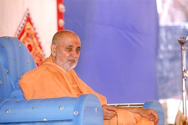 Swamishri seated in the public assembly Next