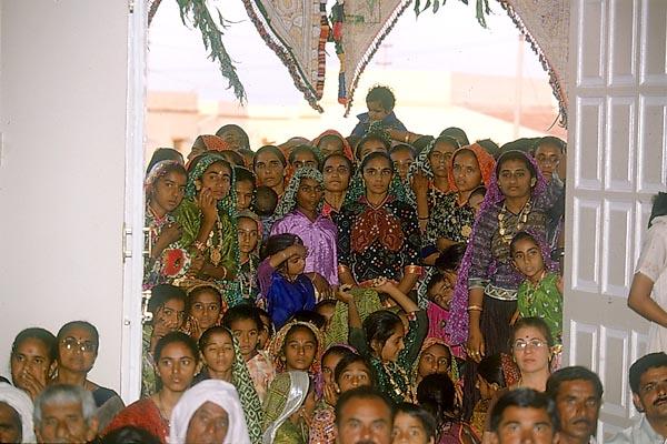 Women devotees seated in the murti pratishtha ceremony 