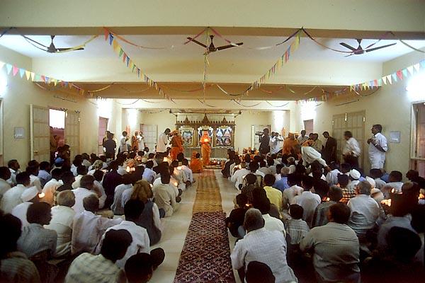 Devotees perform the murti pratishtha arti