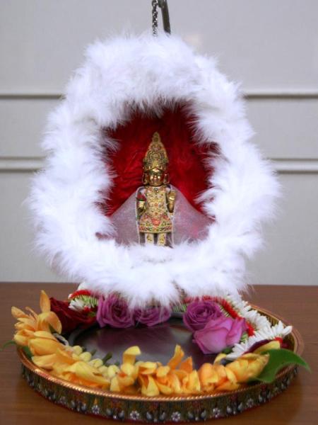 Shri Harikrishna Maharaj in a decorated hindolo