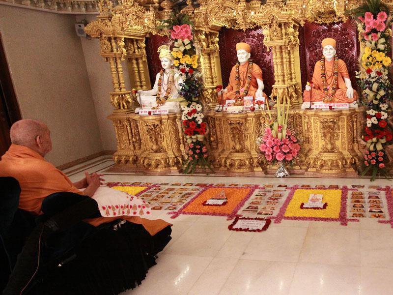  Swamishri engaged in darshan of Shri Guru Parampara