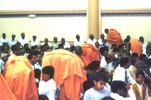 Sadhus tying Raakhdi to devotees in the Hindu tradition of Rakshabandhan