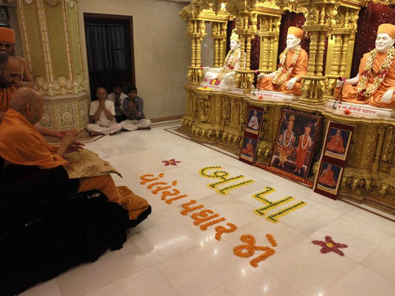Swamishri engaged in darshan of Shri Guru Parampara