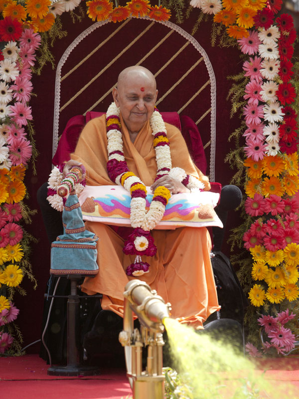  Swamishri starts spraying sanctified colored water on sadhus