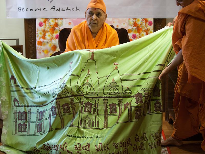  Senior sadhus honor Swamishri with garlands and a shawl