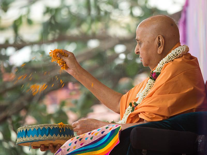  Swamishri blesses all by showering flower petals