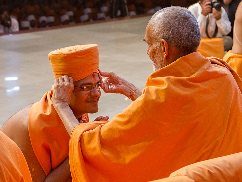 Senior sadhus bless the newly initiated sadhus during the diksha ceremony