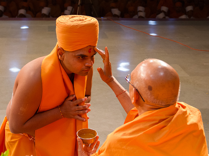 Senior sadhus bless the newly initiated sadhus during the diksha ceremony