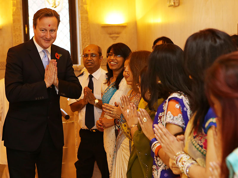 British Prime Minister David Cameron is welcomed at the mandir on the Hindu New Year day