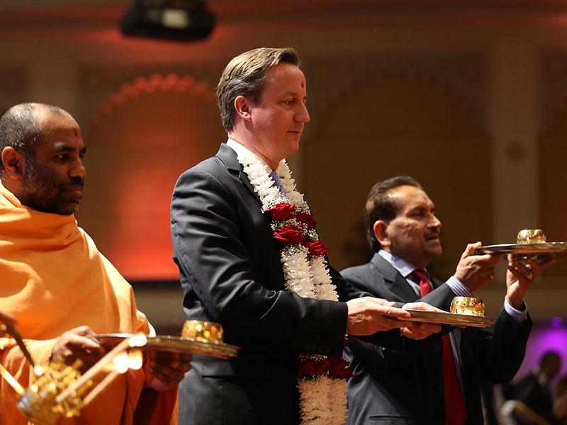 British Prime Minister David Cameron performs annakut arti on the Hindu New Year day
