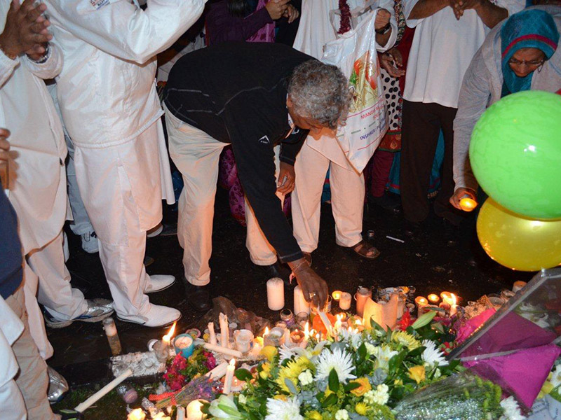BAPS devotees offer flowers and candles outside the home of Nelson Mandela