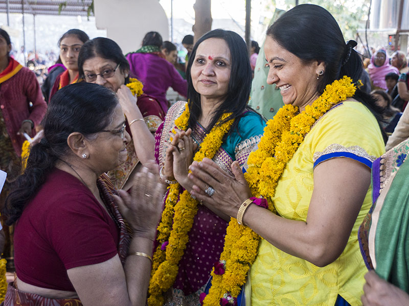 Mothers of the newly initiated sadhus are honored with garlands