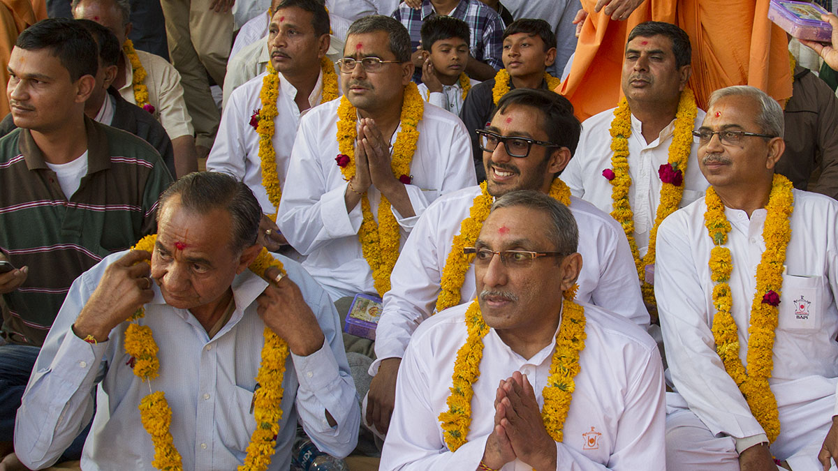 Fathers of the newly initiated sadhus honored with garlands