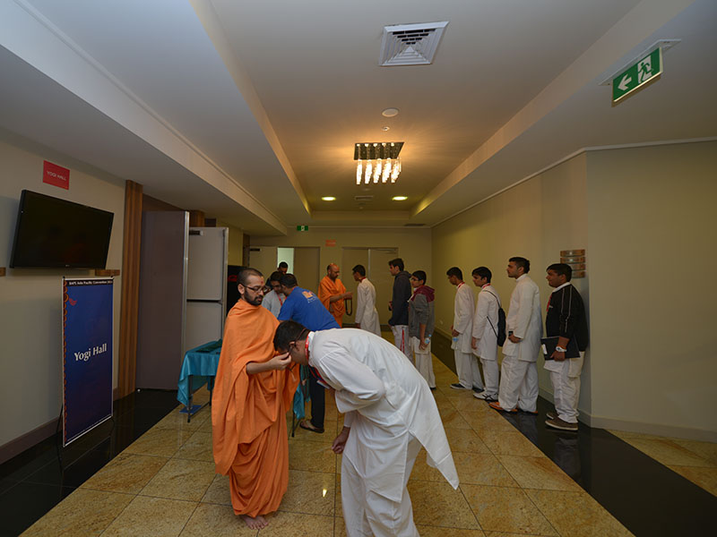 Delegates receiving a mala from sadhus
