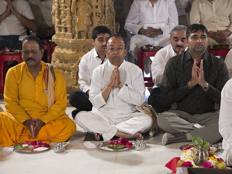 Devotees participate in the mahapuja