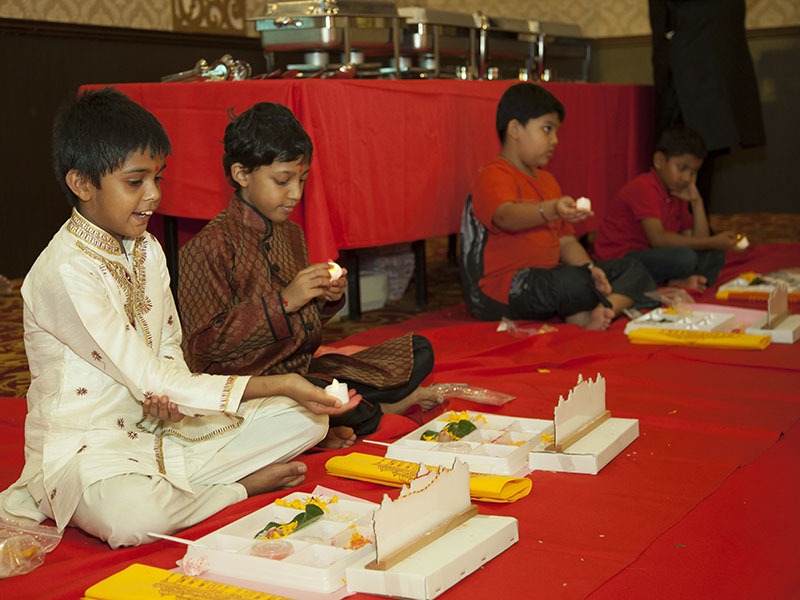 Kids participate in mahapuja rituals