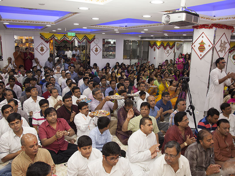 Devotees perform arti