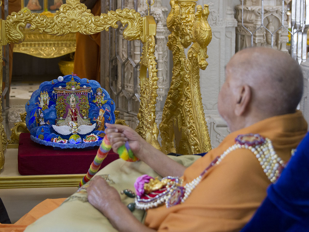 Swamishri swings Shri Harikrishna Maharaj in a decorative hindolo