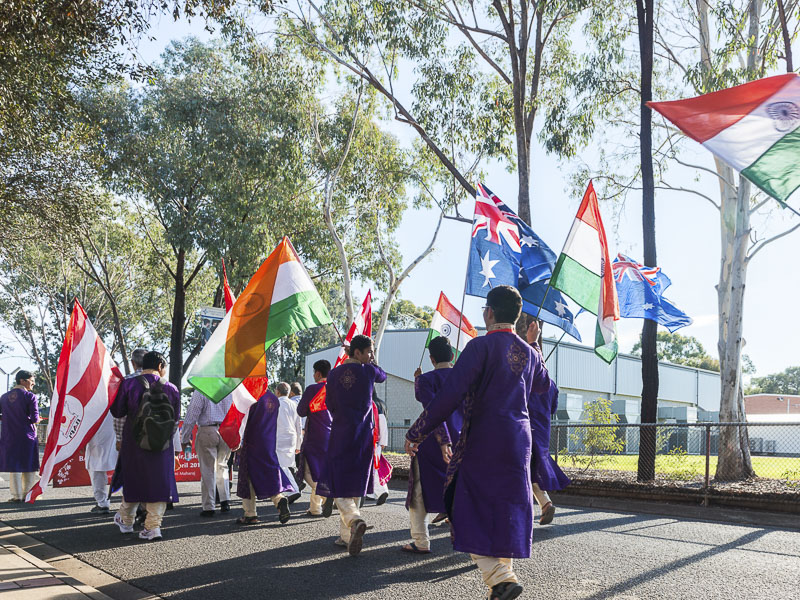 Youths wave flags during the Nagar Yatra