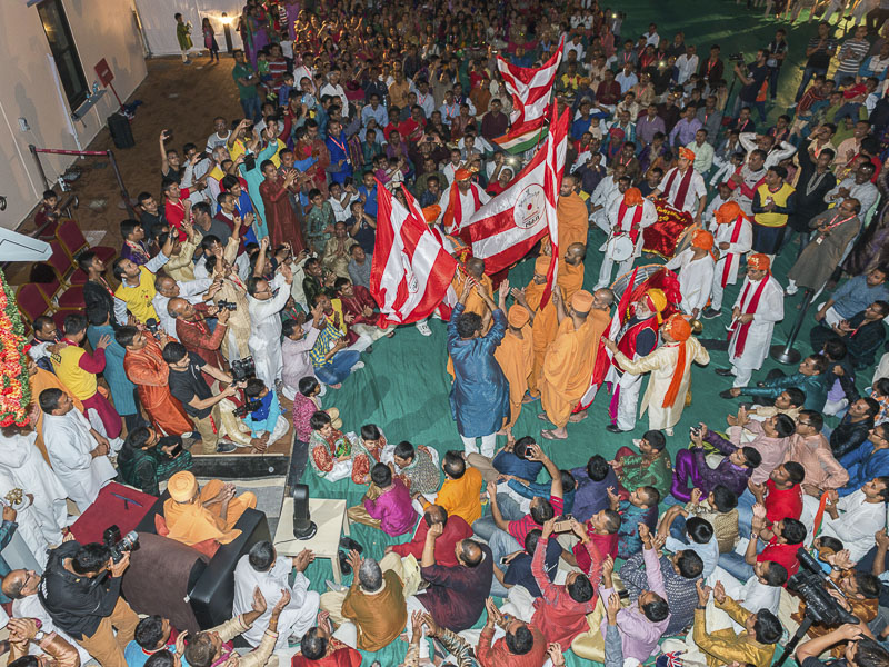 Sadhus and devotees waves BAPS flags